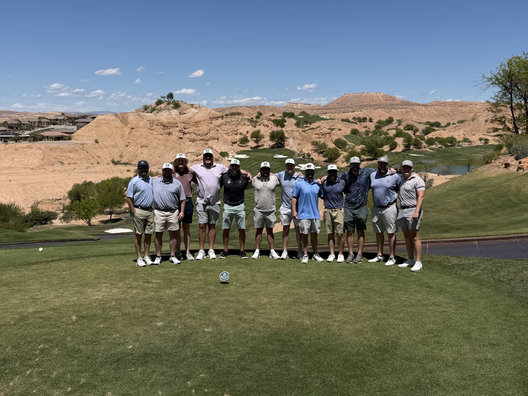 The Stymie Golf trip group standing together on a desert golf course.